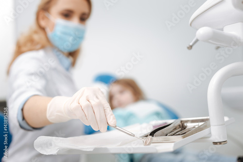 Prominent scrupulous dentist using sterile equipment