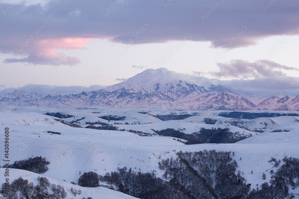 Russia. The formation and movement of clouds above the volcano Elbrus in the Caucasus Mountains in winter.