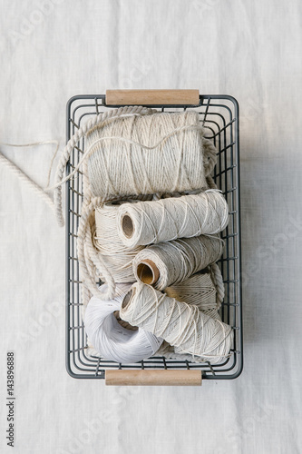 Cotton yarn rolls in a basket photo