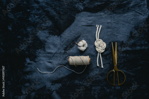 Tabletop with indigo cloth, yarn and scissors