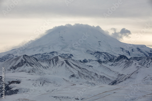 Russia. The formation and movement of clouds above the volcano Elbrus in the Caucasus Mountains in winter.