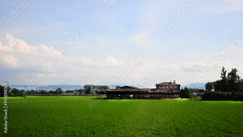 Morning clouds blue sky green meadow pasture perspective © Bohdan