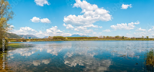 Fototapeta Naklejka Na Ścianę i Meble -  Landscape with man fishing from the shore of lake .