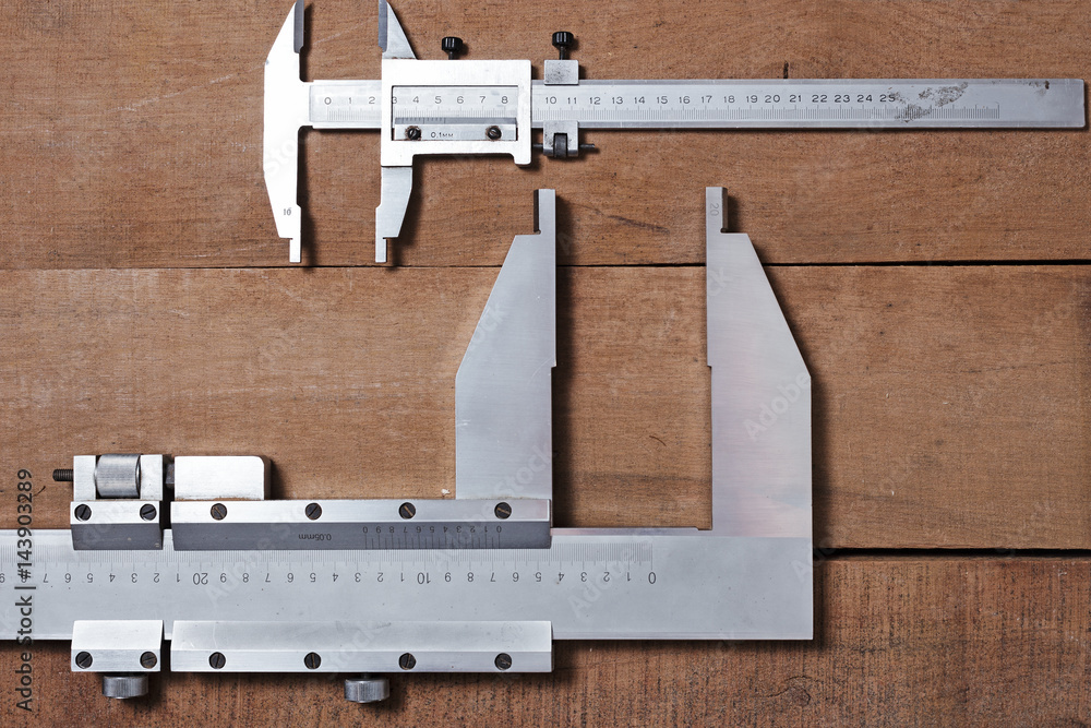 Carpenter tools on the wood table background. Big and small