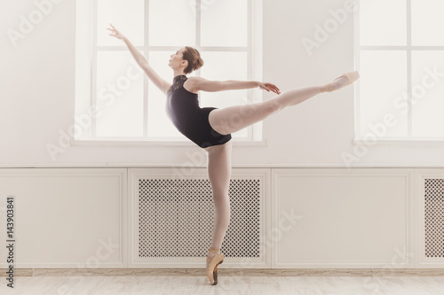 Beautiful ballerina in arabesque ballet position