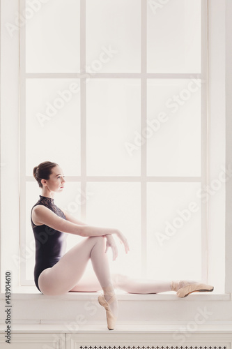 Classical Ballet dancer portrait at window background