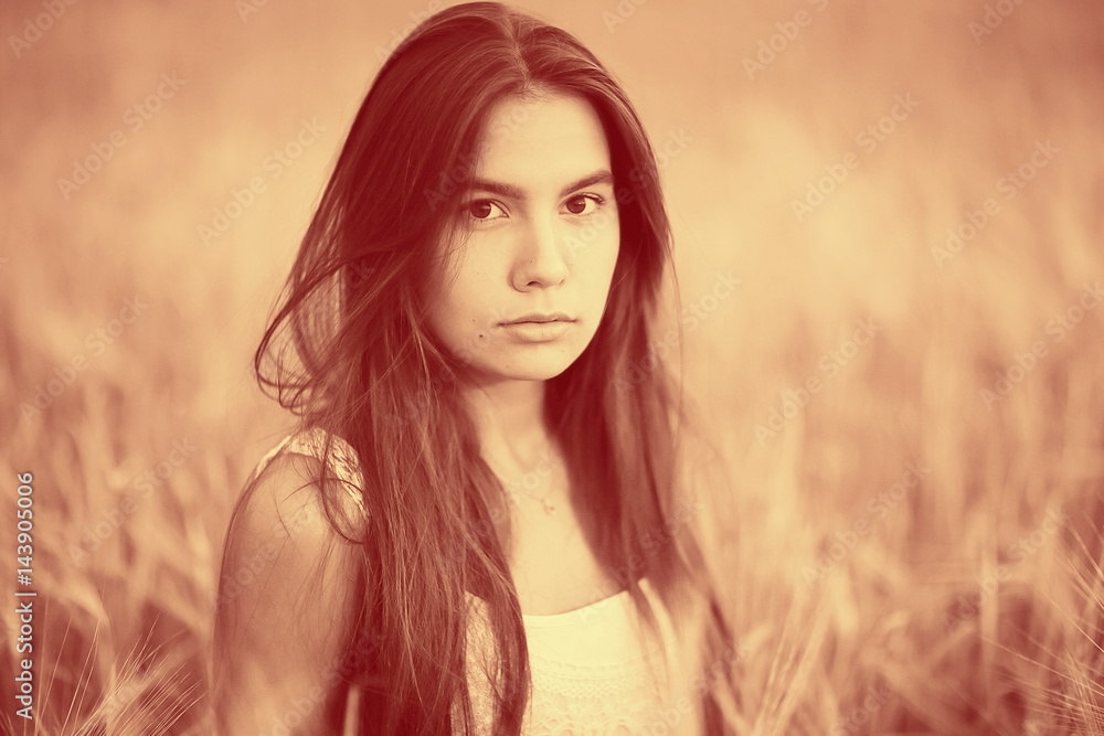 Sad lonely young girl in a field bored with depression Sad lonely young girl in a field bored with depression