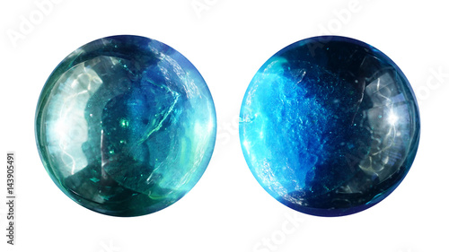 Two transparent round glass balls are close-up similar to alien planets with beautiful lighting, texture and craters.