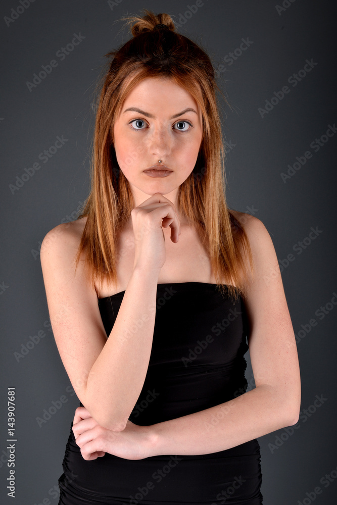 Fototapeta premium Young brunette lady posing on grey background
