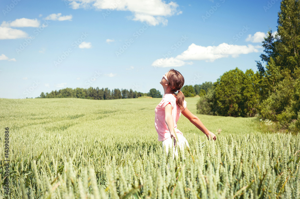 Enjoying the summer! Young happy girl inbreathing soft summer wind Enjoying the summer! Young happy girl inbreathing soft summer wind