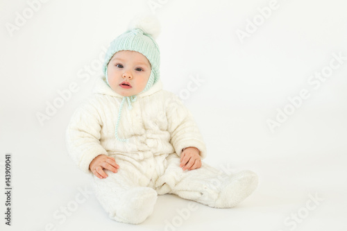 Cute little baby sitting on floor over white background