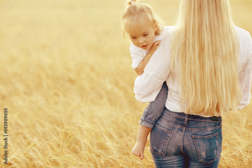 young mother hugging her daughter in a wheat field young mother hugging her daughter in a wheat field