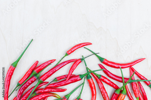 Fresh red hot chilli peppers with spicy on the wooden table with copy space