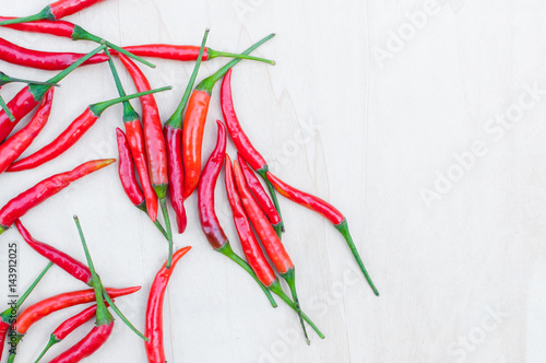 Fresh red hot chilli peppers with spicy on the wooden table with copy space