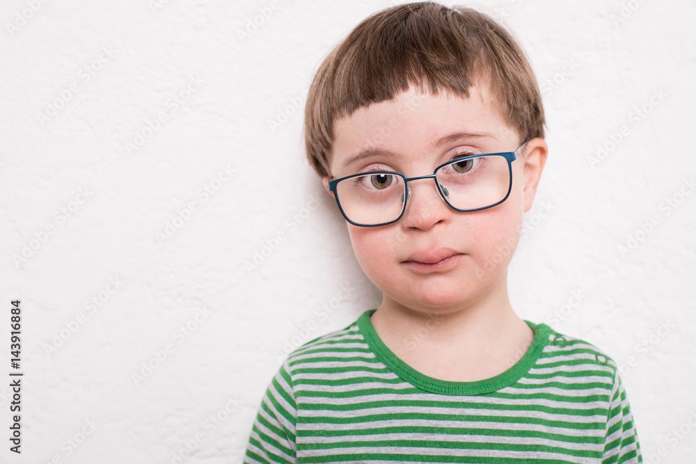 Portrait of young boy with glasses, against white background Portrait of young boy with glasses, against white background