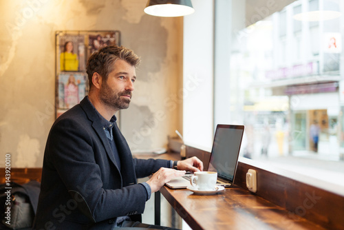 man working with laptop and smartphone