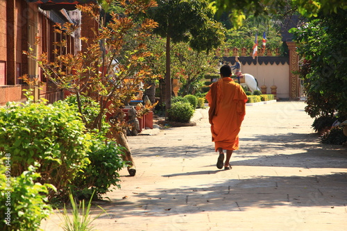 Monk Walking Pass a Temple in Siem Reap, Cambodia