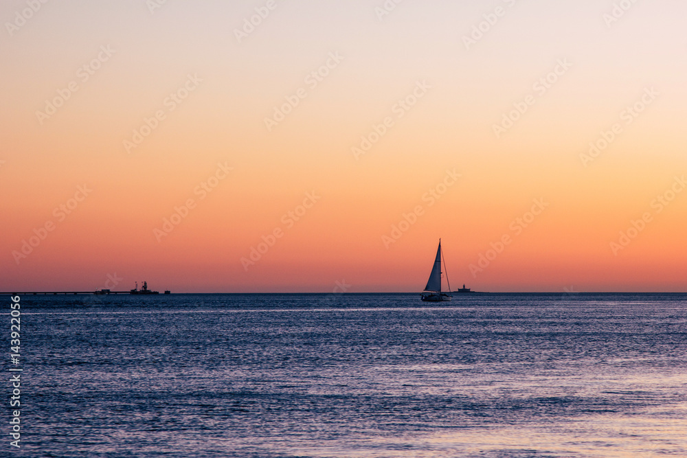 Sailing ship yacht at sunset
