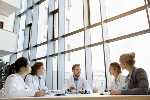 Group of doctors in meeting with consultant photo