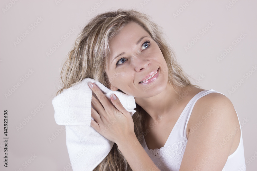 Beautiful woman in white towel wipes her wet hair with a towel Beautiful woman in white towel wipes her wet hair with a towel