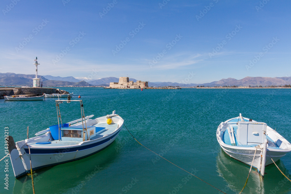 Traditional Fishing Boats, Lightouse and Bourtzi Fortress in Nafplion, Greece