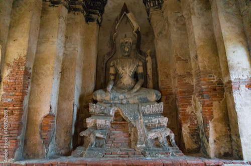 Ancient ruins of Buddha statue at Wat Chai Wattanaram temple