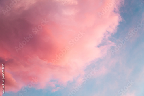Photography Beautiful sky background with pink fluffy colored cloud looks like cotton candy or candy-floss at sunset with sun setting down