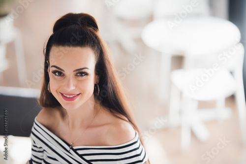 Close up portrait of an attractive adult woman with a perfect smile looking at the camera.