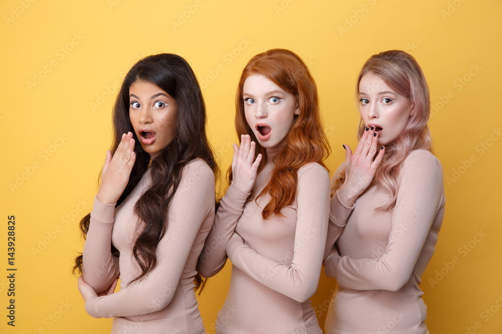 Three suprised ladies with crossed arms posing in studio Three suprised ladies with crossed arms posing in studio