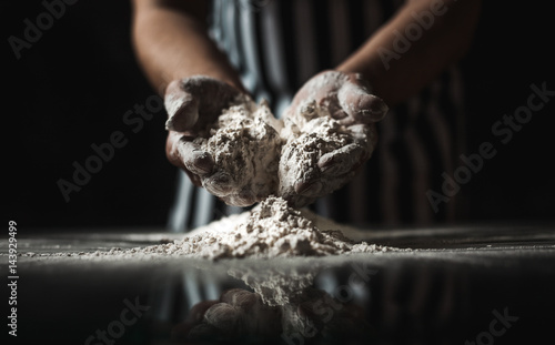 Male chef prepares a meal of flour