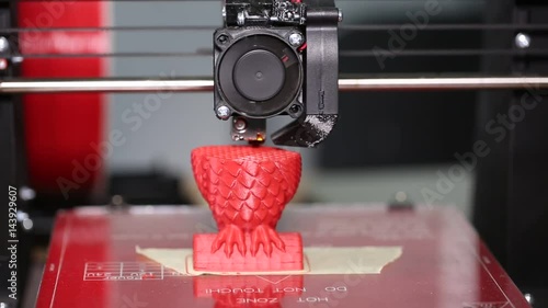 3d printer is typing 3d model of a red owl. The video is shot close-up. This video was shot using Canon 5d Mark 3. If you liked this video, rate it, please! photo