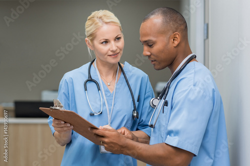 Nurses checking medical reports photo