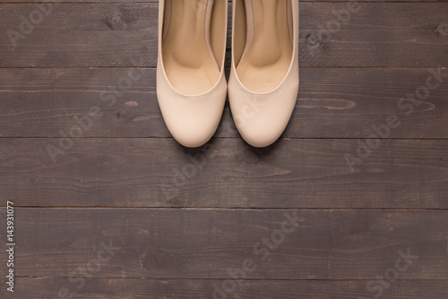 High heels are on wooden background with copy space