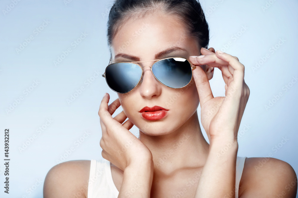 Stylish young woman in blue mirrored sunglasses Stylish young woman in blue mirrored sunglasses