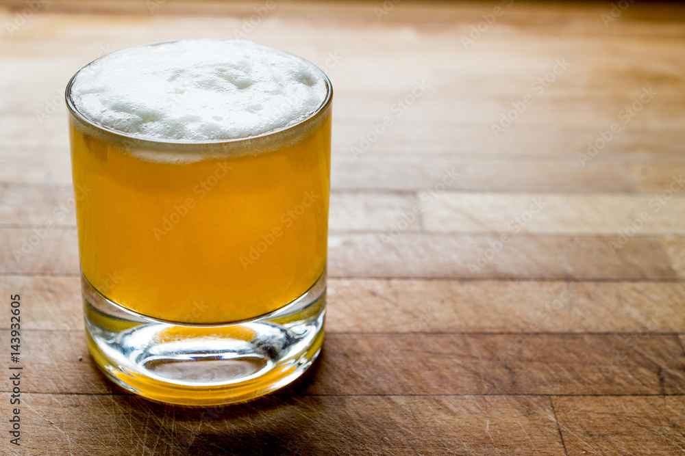 Whiskey sour cocktail with foam on wooden surface. Whiskey sour cocktail with foam on wooden surface.