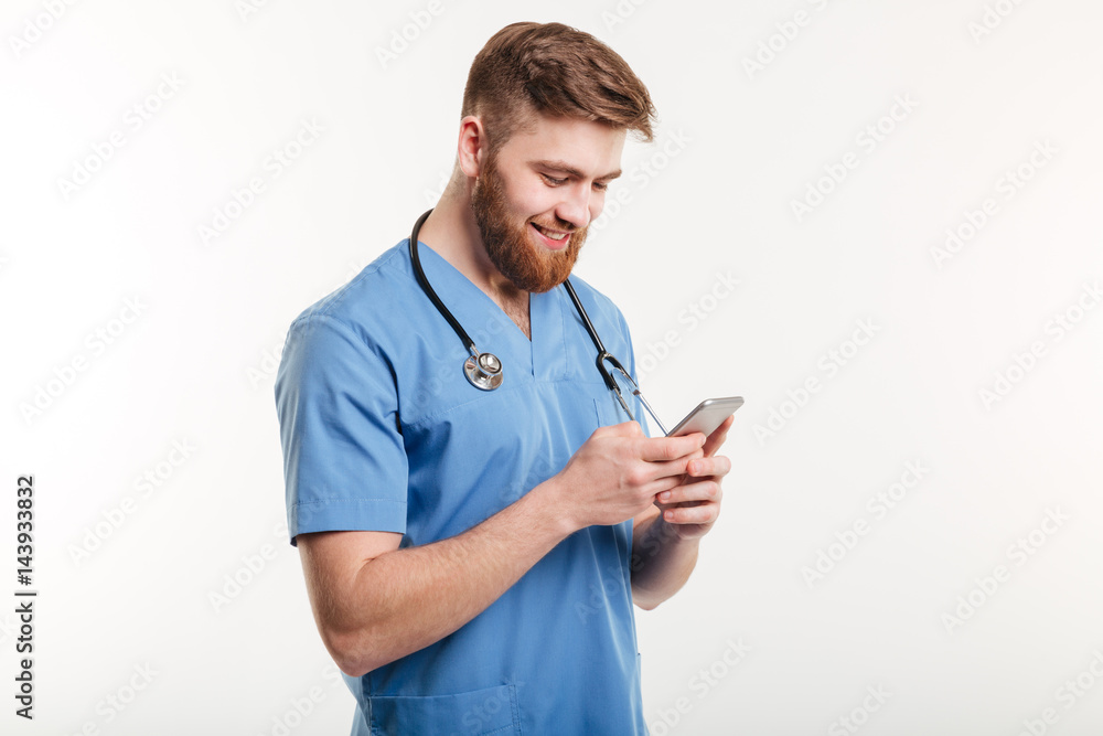 Portrait of man doctor with stethoscope using smartphone. Portrait of man doctor with stethoscope using smartphone.