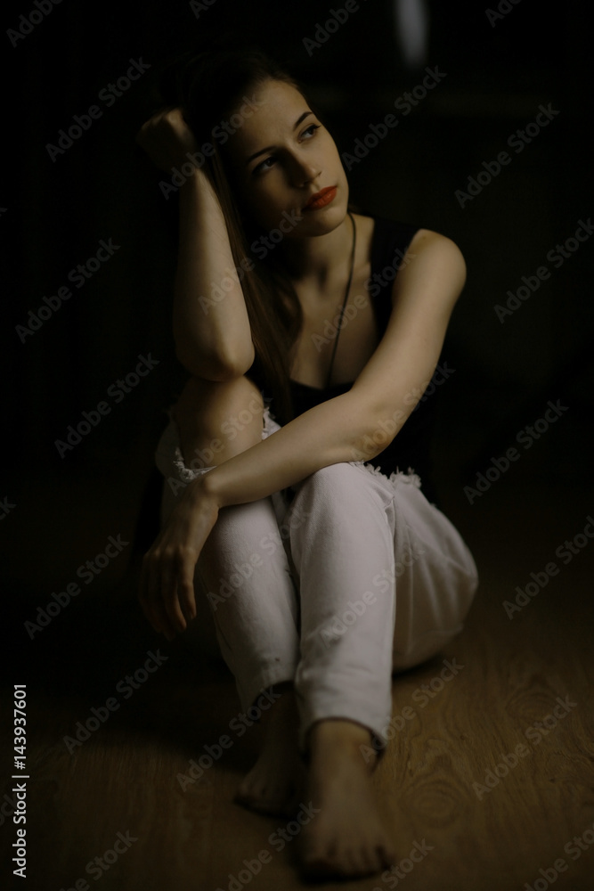 Studio portrait of a beautiful brunette on a black background Studio portrait of a beautiful brunette on a black background