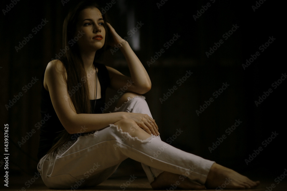 Studio portrait of a beautiful brunette on a black background Studio portrait of a beautiful brunette on a black background