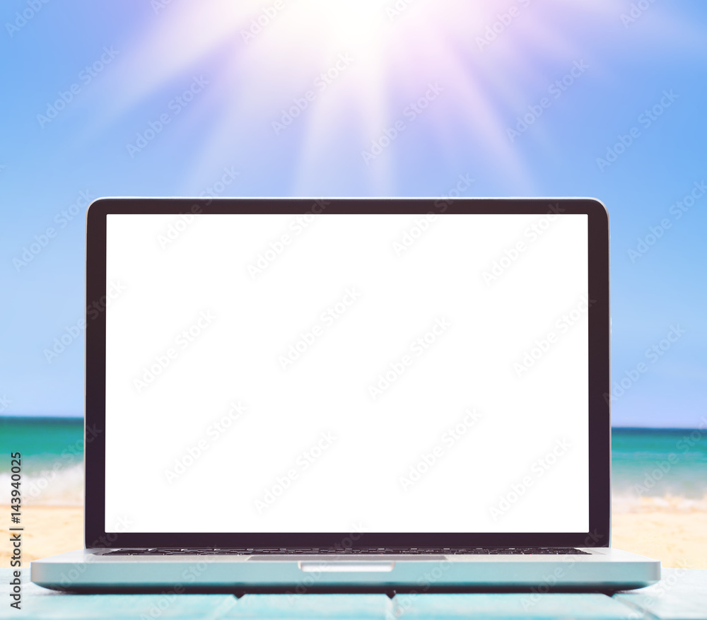 Modern laptop on blue wooden table with blank screen at tropical beach Modern laptop on blue wooden table with blank screen at tropical beach