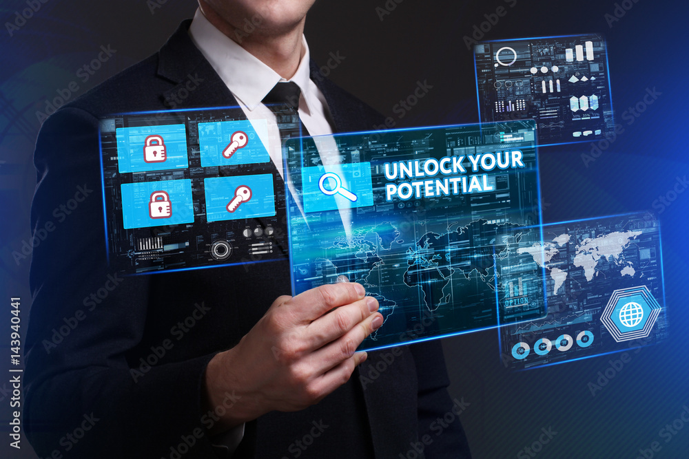 Business, Technology, Internet and network concept. Young businessman working on a virtual screen of the future and sees the inscription: Unlock your potential Business, Technology, Internet and network concept. Young businessman working on a virtual screen of the future and sees the inscription: Unlock your potential