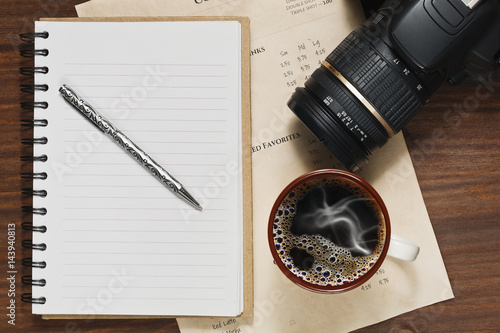 Wallpaper Mural Coffee in cup, notebook and a DSLR camera on the table Torontodigital.ca
