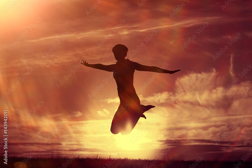 Silhouette of a girl against the sky jumping at sunset, concept of happiness