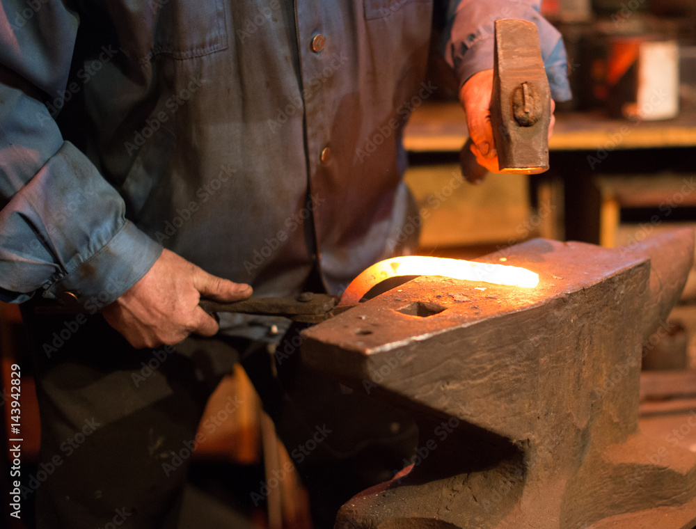 Making of horseshoe. Male worker with pliers and hammer making horseshoe. Making of horseshoe. Male worker with pliers and hammer making horseshoe.