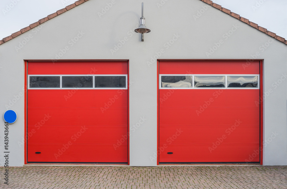 Fototapeta premium Garage für LKW mit zwei modernen roten Rolltoren - Garage for trucks with two modern red roller doors