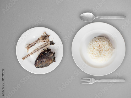 Photos Poor meal of rice and fish bones.