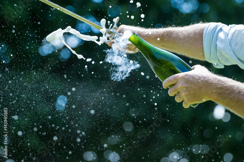Quadro su tela Close up image of a bottle of champagne being opened with a sword, also called s