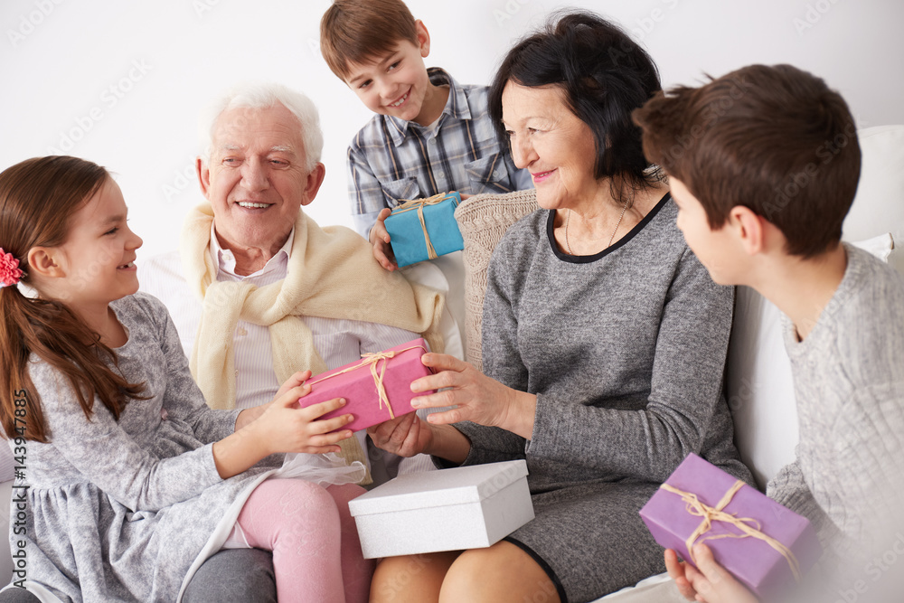 Grandparents and grandchildren exchanging gifts Grandparents and grandchildren exchanging gifts