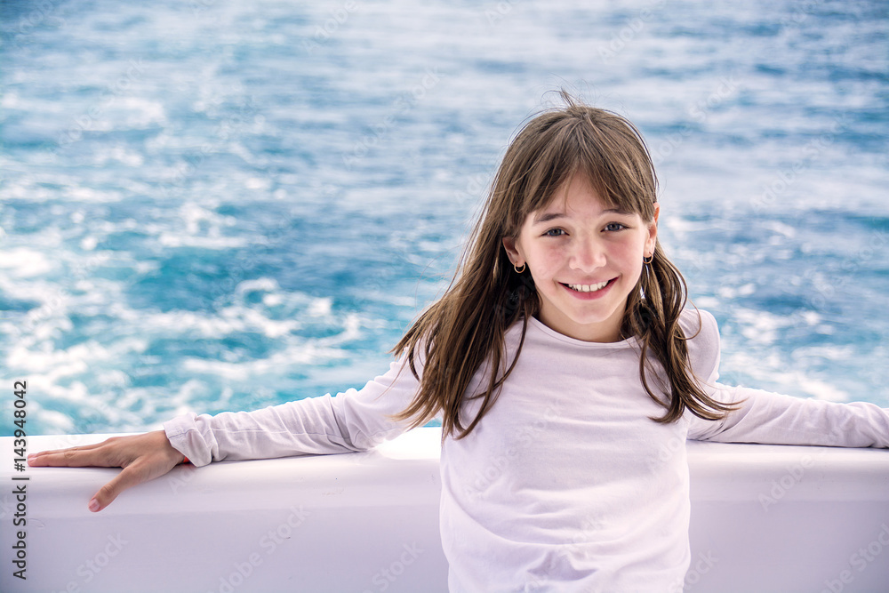 Portrait of a beautiful teenage girl on a yacht, on the background of the sea