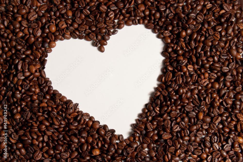 Coffee beans background forming a white heart Coffee beans background forming a white heart
