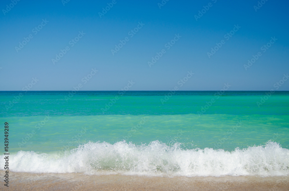 Waves crashing on the beach on a sunny day Waves crashing on the beach on a sunny day